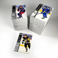 Two stacks of 2021 Upper Deck hockey cards and one single card with a Pittsburgh Penguins player on top.