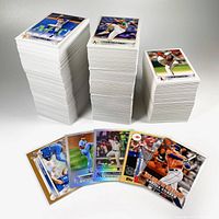 Three large stacks of 2022 Topps baseball base set cards, each topped with a visible player card (Kevin Pillar, Chris Bassitt, Shohei Ohtani), and a set of holographic and special insert cards in front.