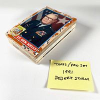 Stacked 1991 Topps and Pro Set Desert Storm trading cards on white background with handwritten note.
