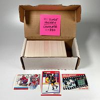 Open cardboard box revealing complete stack of 1991 Score Canada hockey cards 1-330 inside.