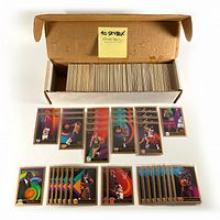 Full box filled with 1990 Skybox basketball cards and several cards displayed in front showing variety and condition.