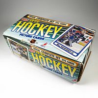 Closed view of the original 1990 Topps hockey picture cards wax box, showing box graphics and text indicating an official complete set of 396 cards.