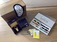Overview of all three items: melting clock, Mercury watch box, Invicta watch set