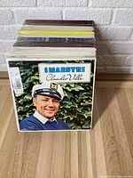 Stack of vinyl records with visible cover 'I Maestri Claudio Villa' showing Claudio Villa in sailor's hat.