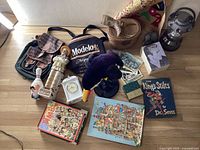 Wide shot of the entire lot including plush toucan, hats, ceramic figures, books, and a cooler bag