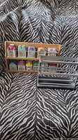 Two spice racks displayed on a zebra-print fabric background: one wooden rack with colorful ceramic townhome spice jars, and a smaller metal and wood rack.