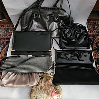 Image showing eight purses in various materials and styles including synthetic leather tote, patent leather pouches, fabric clutches and vintage style floral purse.