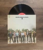 Photo of Blood, Sweat & Tears 3 LP vinyl record with album cover showing band members posing outdoors.