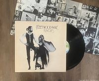 Photo of Fleetwood Mac Rumours vinyl LP record with album cover and inner sleeve containing band photos.