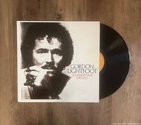 Photo of Gordon Lightfoot Summertime Dream LP vinyl partially out of cover showing black disc and front cover with monochrome portrait of Gordon Lightfoot.