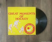 Yellow album cover with red text and hockey player illustrations, along with Hockey Night in Canada logo and partially visible black vinyl record.