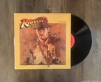 Front cover and visible vinyl record for Raiders Of The Lost Ark original soundtrack