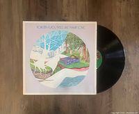 Vinyl LP record 'Feel Like Makin' Love' by Roberta Flack with matching album cover. Photo shows record partially pulled out of cover on a wooden surface.