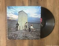 Image of The Who - Who's Next LP vinyl record partially out of its album cover, showing the cover art and part of the black vinyl disc.