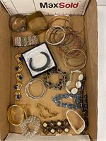 Tray with all bracelets visible, showing assortment of styles and materials