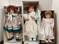 Three collector dolls in boxes showing full view of dolls and packaging