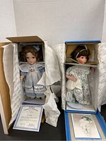 Gwendolyn and Me and My Blankie dolls in open boxes with Certificates of Authenticity