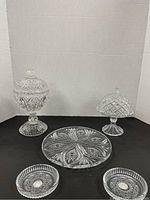 Full view of the set including tall pedestal candy dish, smaller pedestal dish, glass platter, and two small bowls.