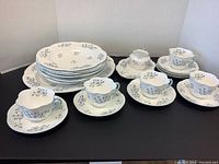 Overview of all Shelley Blue Rock pieces: bowls, cups with saucers, creamer, plates, platter