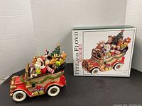 Side view of the Fitz and Floyd Santa Mobile figurine with original box showing colorful, detailed holiday scene on vintage car.