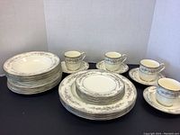 Overall shot of Noritake Shenandoah pattern china set showing plates, bowls, cups and saucers stacked and arranged for display.
