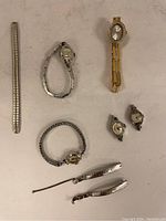 All eight watches laid out on white background showing various bracelet styles and watch heads