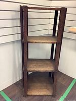 Front view showing the full height, 3 shelves, and the vertical slatted side support structure.