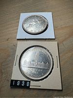 1937 and 1939 Canadian silver dollar coins shown from the reverse side, highlighting the rider on horseback and Parliament Buildings respectively.