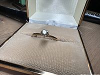Front view of the diamond solitaire ring in jewelry case