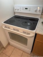 Three-quarter front view showing cooktop, control panel and oven door