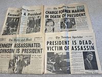 Group flat lay showing multiple newspapers with headlines about JFK assassination including The Hamilton Spectator and The Globe and Mail