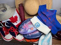 Overview of knit slippers including navy, white, and red high-top style sneakers, fish slippers, knit socks, hats, and umbrellas.
