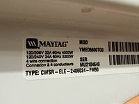 Close-up of the electrical rating and model info label showing power specifications, model YMDE5600TQ0, serial MU2104649