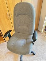 Front view of the gray fabric high back office chair showing padded seat, backrest with ergonomic contours and padded armrests.
