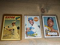 Photo of Gary Carter, Ernie Banks, and Mickey Mantle baseball cards in clear protective holders