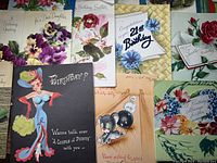 Overview of vintage greeting cards featuring floral designs and cartoon character birthday cards.