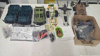 Top-down view of disassembled vehicle bodies, parts, figures and decals