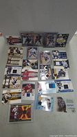Full lot of 19 hockey cards spread out showing various game-used patch and autograph cards.
