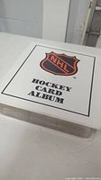 White NHL Hockey Card Album binder with NHL logo and text on front.