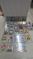 Full display of 45 football cards arranged in 5 rows, all in protective top loaders showing various players and years.