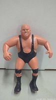 Front view of 1985 King Kong Bundy LJN wrestling figure wearing black singlet and boots, showing muscular physique and bald head.