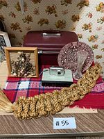 Full view of lot items including Samsonite case, camera, macrame, table runner