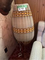 Full view of lamp showing tripod teak base and tall fabric shade