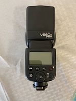 Godox V860II camera flash front view showing LCD screen and control buttons