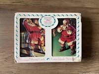 White and teal accented box of Nostalgia Playing Cards featuring two images of Santa Claus with Coca-Cola, limited edition 1993, sealed.