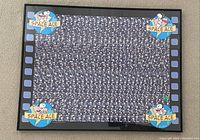 Framed 3D Holusion artwork featuring Snoopy as Space Ace from Peanuts in a film strip style black and blue frame, showing the 3D image composed of small repeating Snoopy astronaut figures around borders with a black textured background.