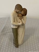 WillowTree Our Gift sculpture showing a man and woman holding baby in an embrace.
