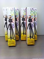 Six boxes of Soligor T175 camera tripods standing upright showing front panels with product images and branding.