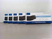 Five boxed Insignia ergonomic wireless keyboards lined side by side, showing front packaging.