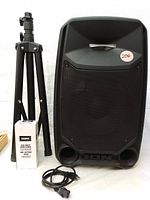 Front view of ION Freedom PA speaker, tripod stand, wireless microphone box, and power cord displayed together showing physical condition and included items.